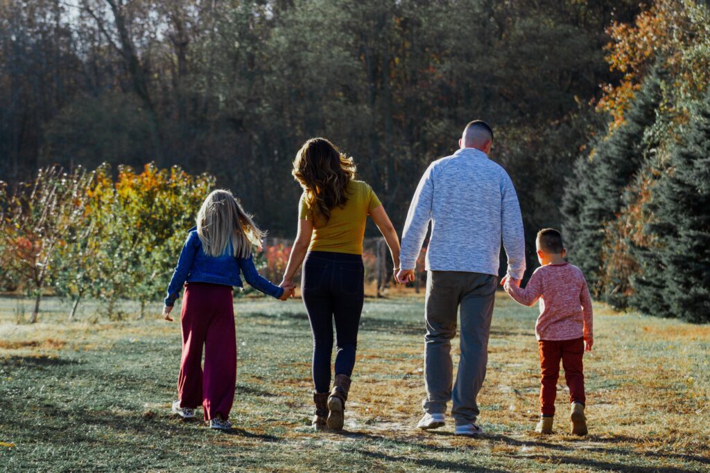 family walking in a field